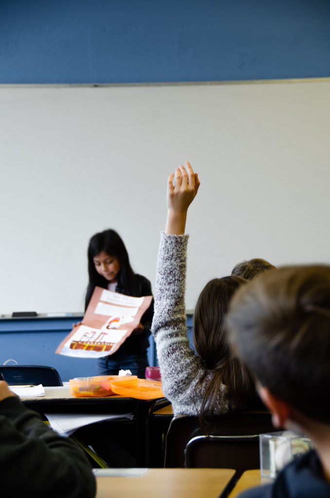 Student raising hand in class