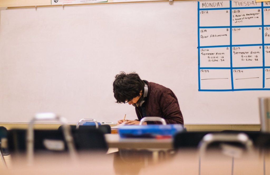 Student taking notes in classroom